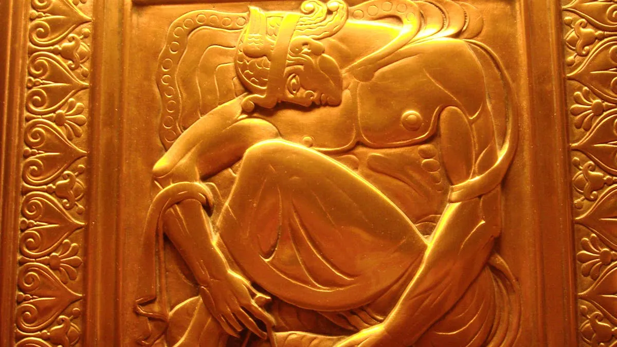 Art Deco gold relief sculpture showing the geometric patterns and elegant forms characteristic of the style Erté helped define