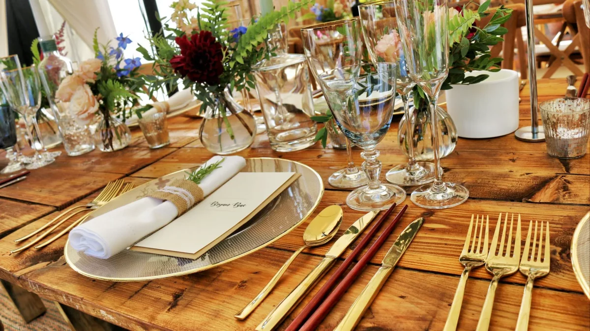 Antique sterling silver flatware collection displayed on dark velvet