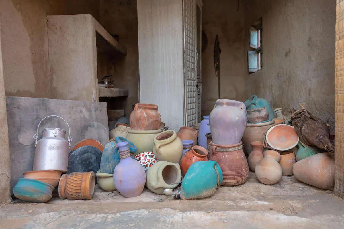 Collection of vintage handcrafted pottery pieces similar to Weller art pottery styles